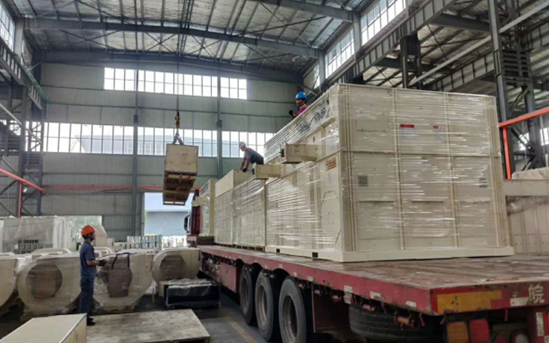 FMWorld grain dryer components being loaded onto a truck at the factory